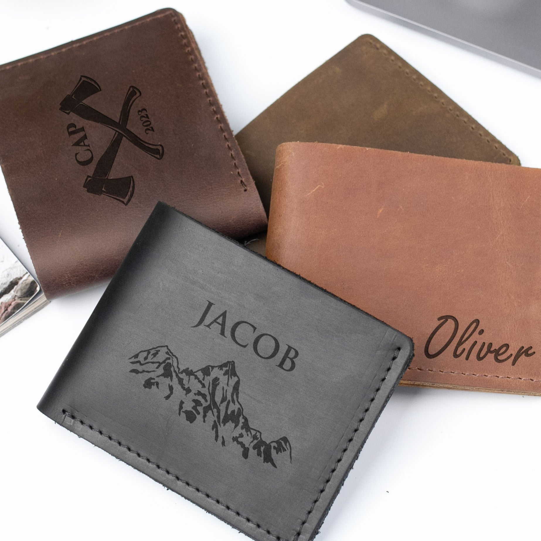 a collection of leather wallets and card holders, each with unique designs and names printed on them.