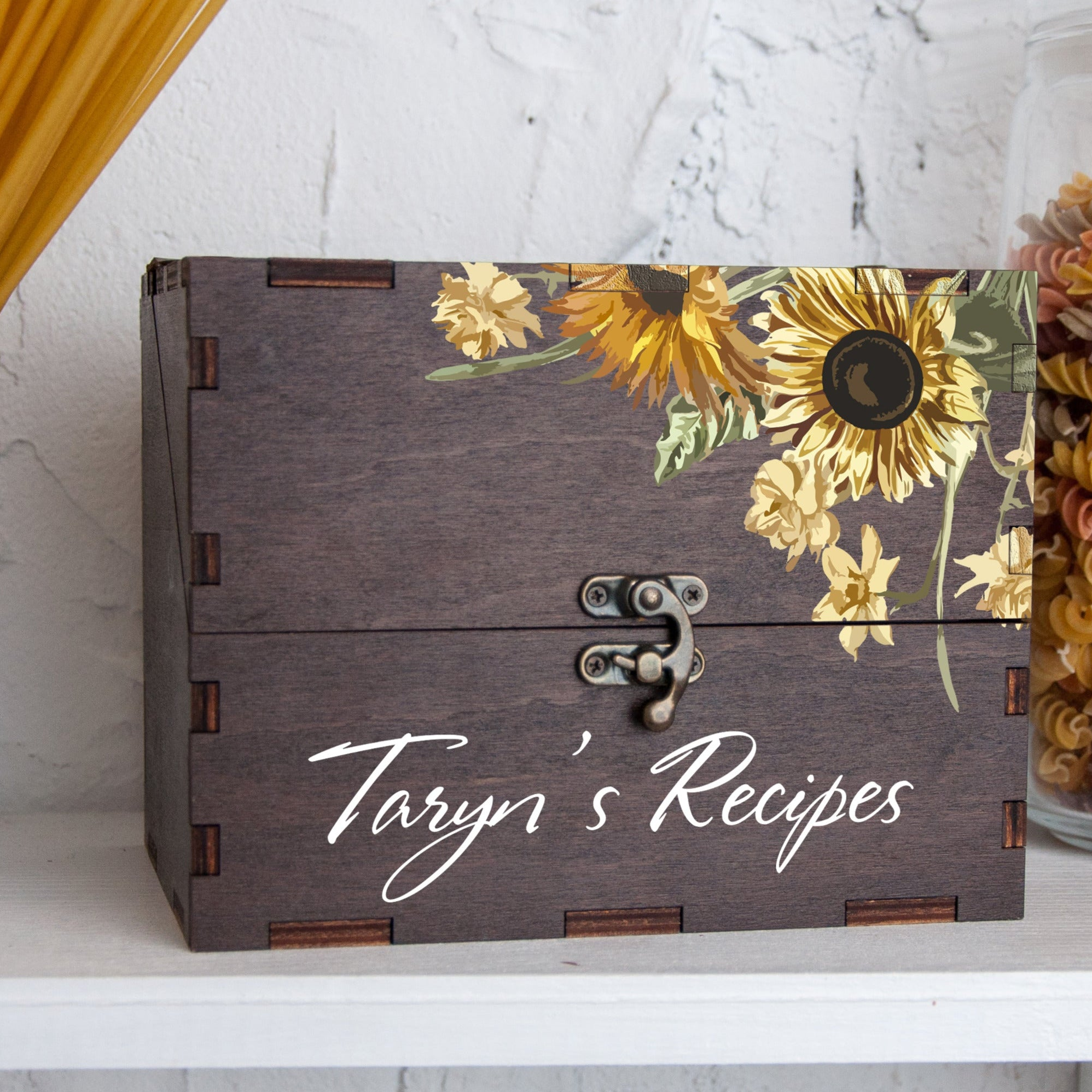 A wooden recipe box with a floral design and the name "Taryn's Recipes" printed on it.
