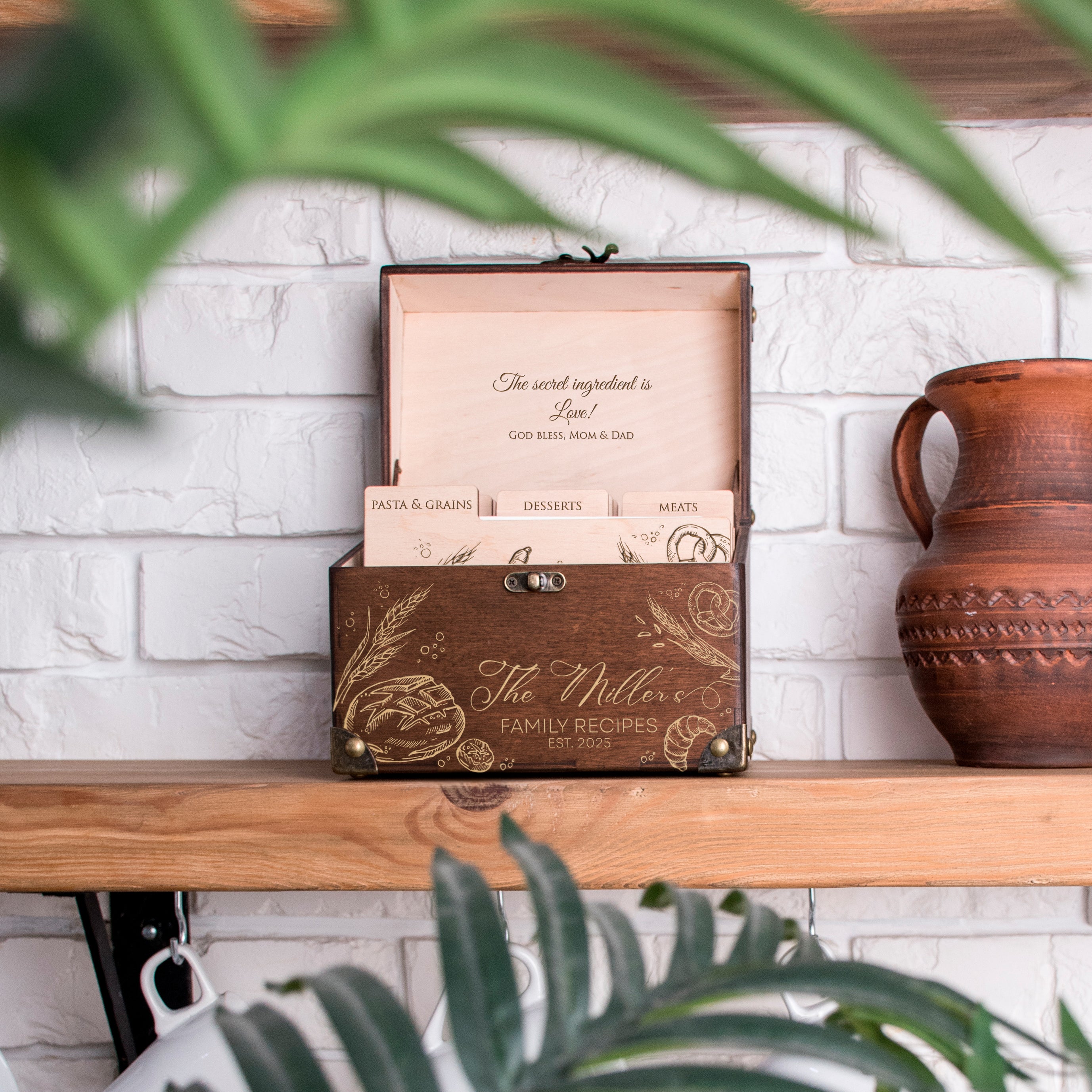 A wooden box with a decorative design and text on it, placed on a wooden shelf next to a vase.