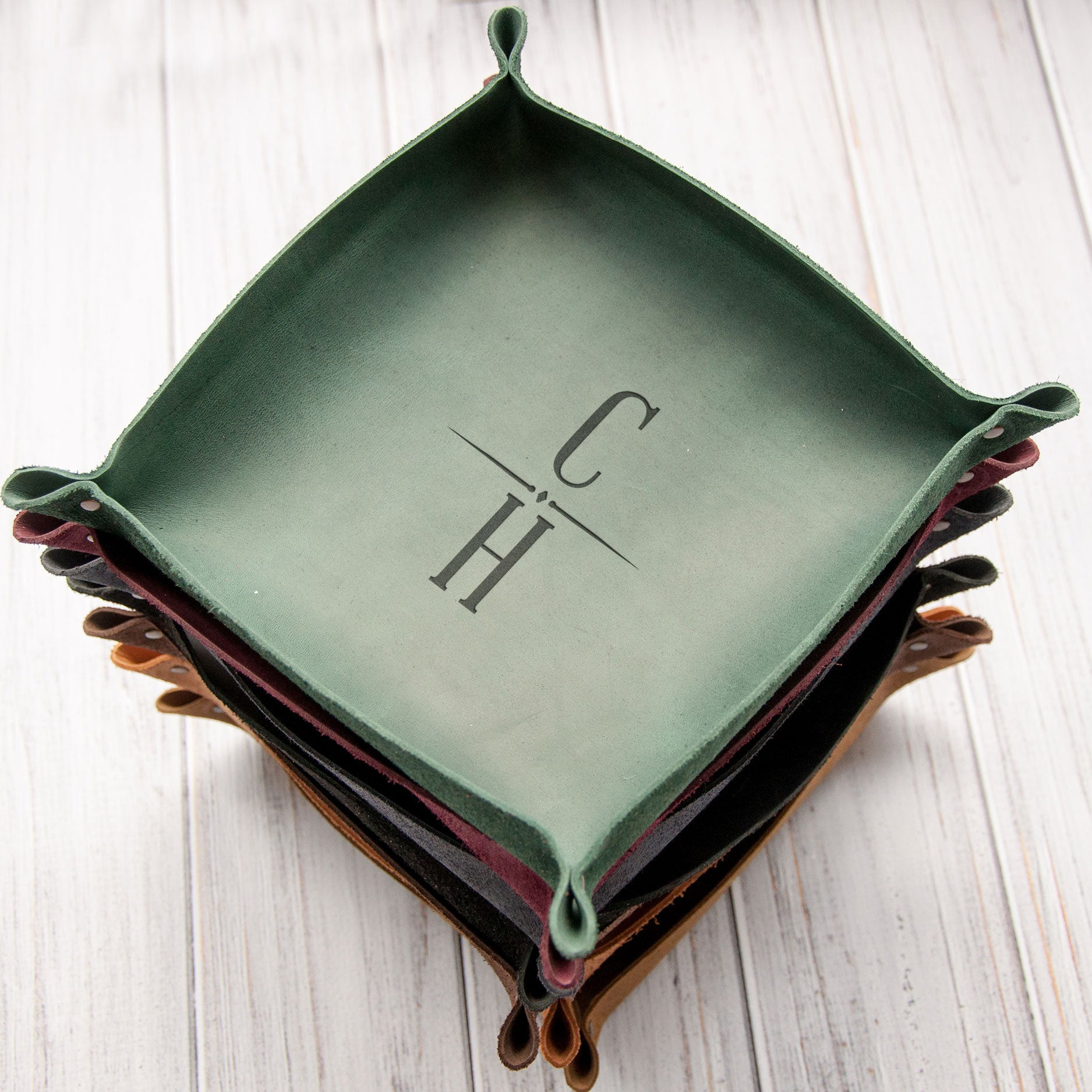 A stack of green trays with the letters "CH" printed on them.