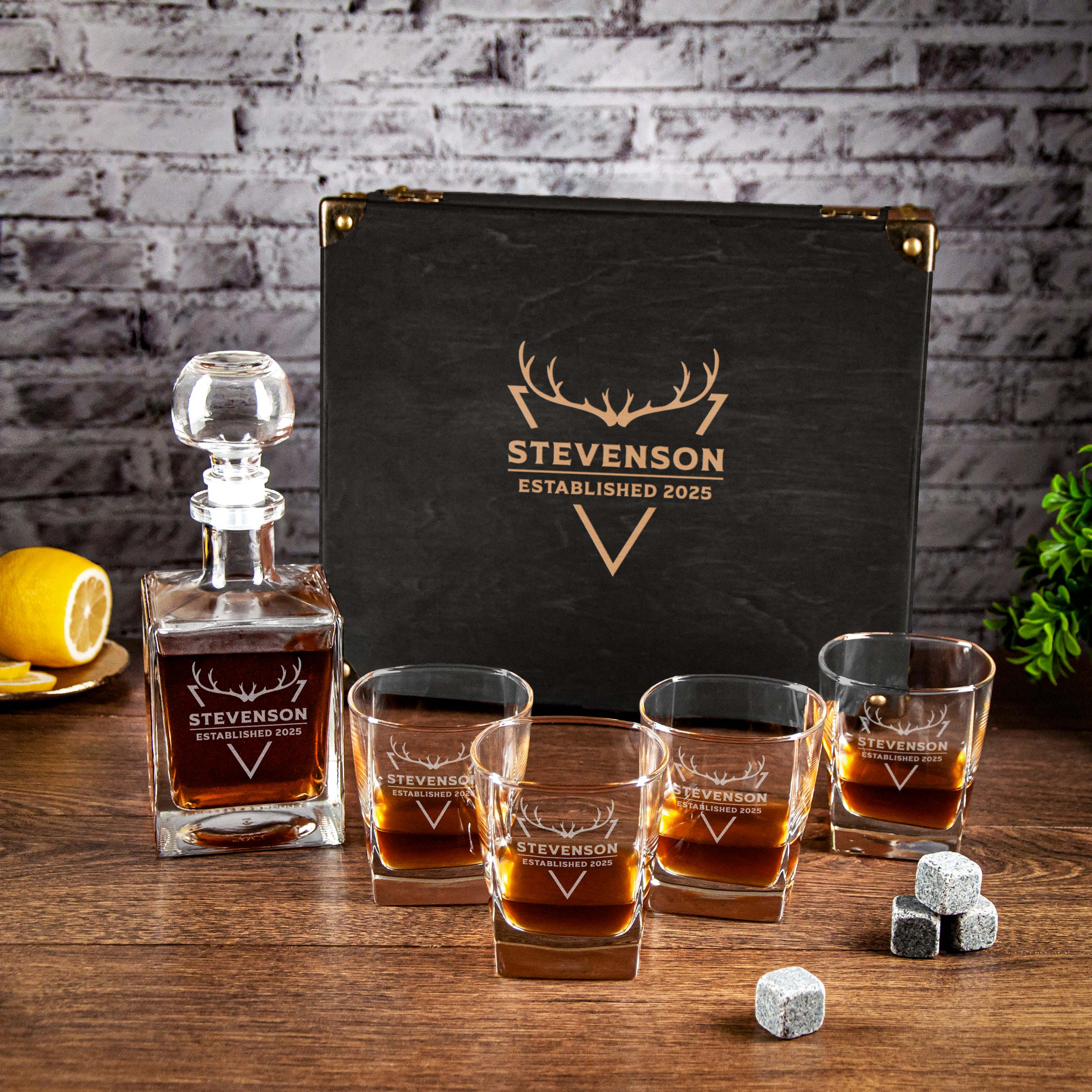 a bottle of whiskey and a set of whiskey glasses, all placed on a wooden table. The bottle has a label that reads "Stevenson ESTABLISHED 2025", and the glasses are arranged in a row, with the first one being the largest. There are also some small gray cubes placed next to the glasses.