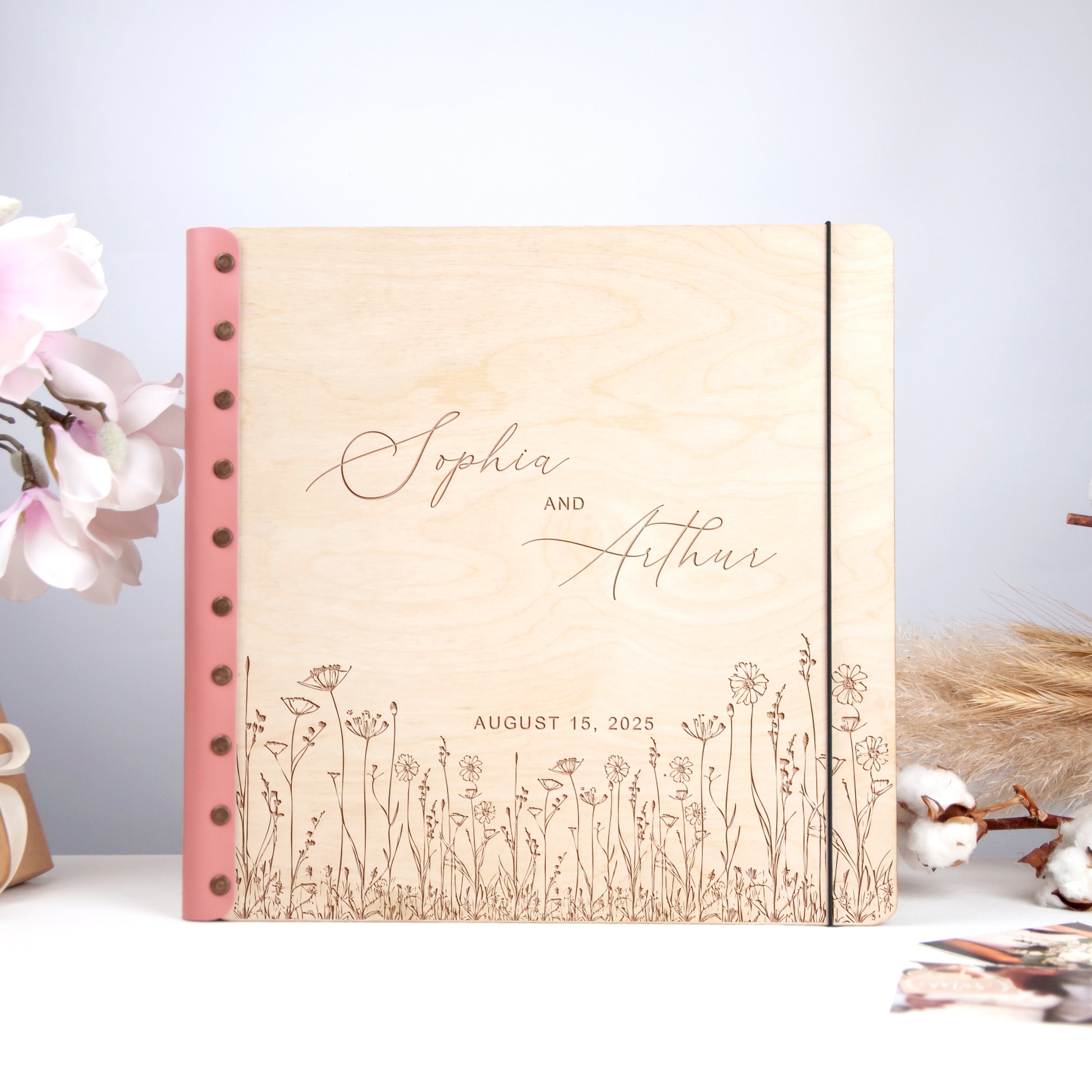 A wooden photo album with a floral design, featuring the names 'Sophia and Athanasios' and the date 'August 15, 2020'.