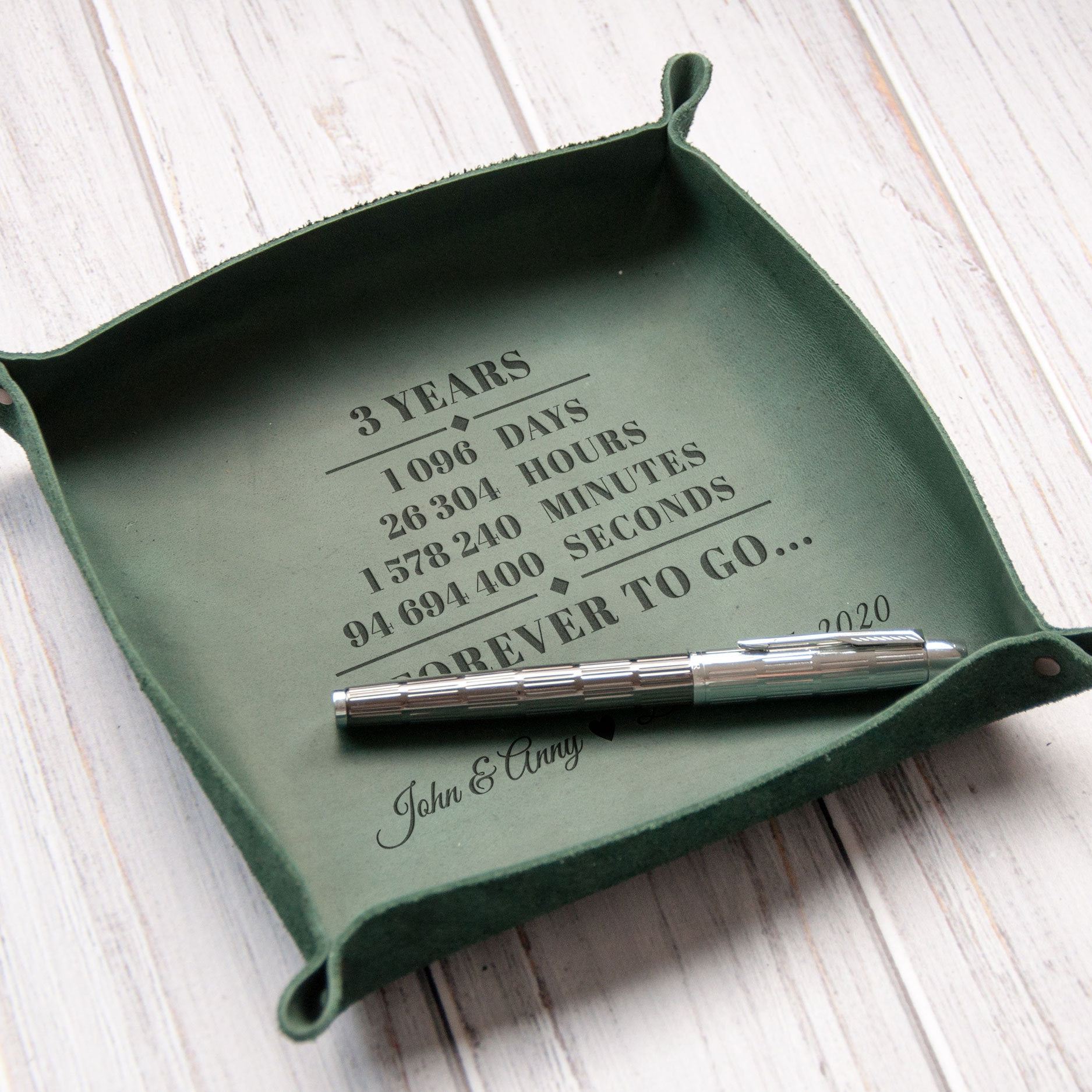 A green tray with a pen on it, and the text "3 YEARS" printed on it.