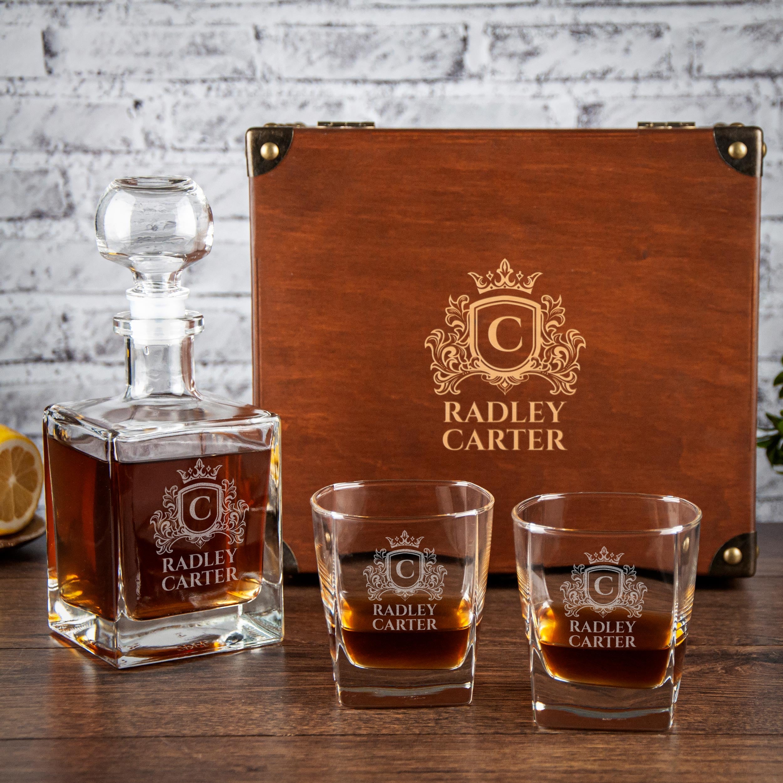 a wooden decanter and three glasses, all branded with the name "RADLEY CARTER". The decanter is placed on a wooden surface, and the glasses are positioned in front of it.